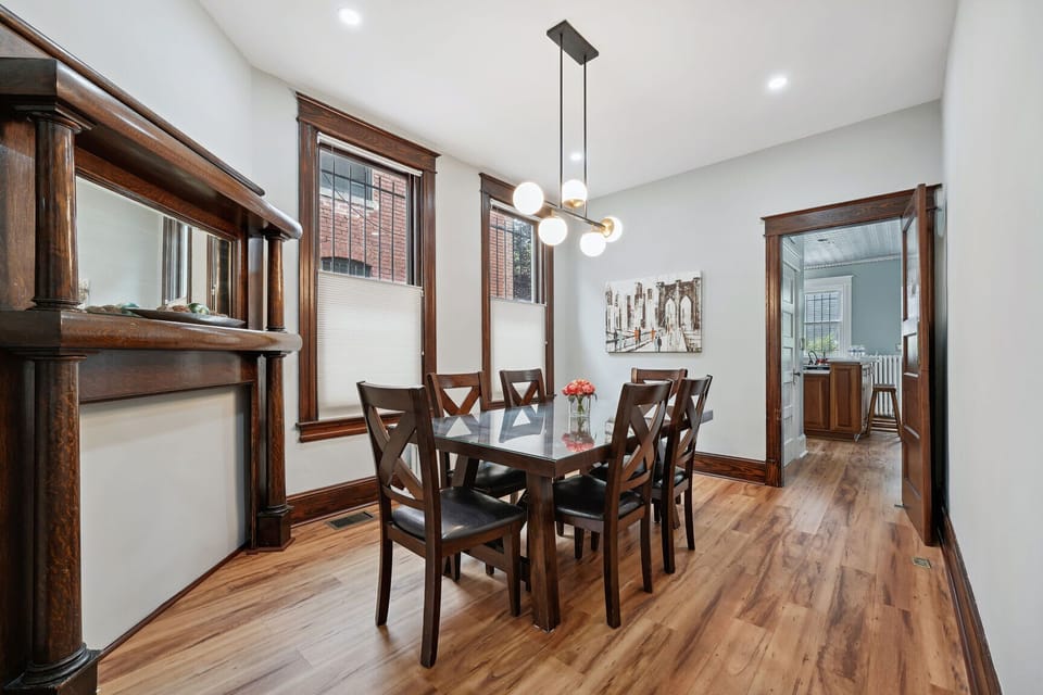 Elegant dining room with vintage woodwork, modern lighting, and cozy charm