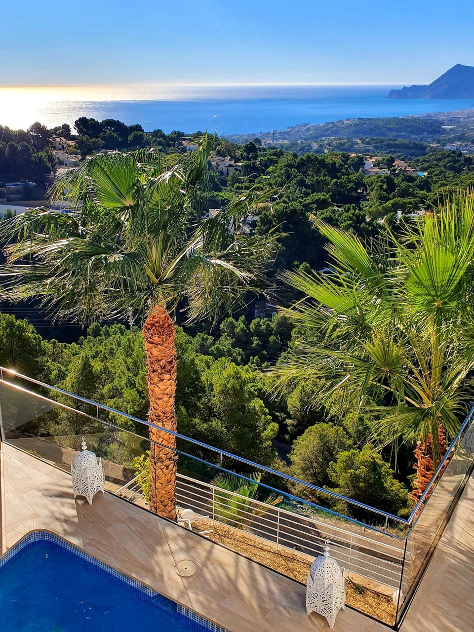 Side view of pool with sun loungers