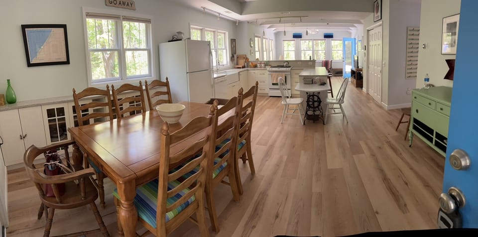 Dining area adjacent to the kitchen. Table seats 8. Space at the bar seats 8 too