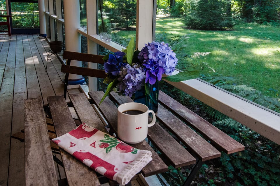 Sip morning coffee on the screened porch that stretches across the house's front