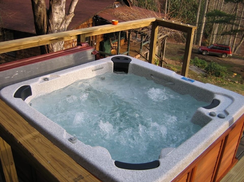 Hot Tub on deck overlooking property, mountains