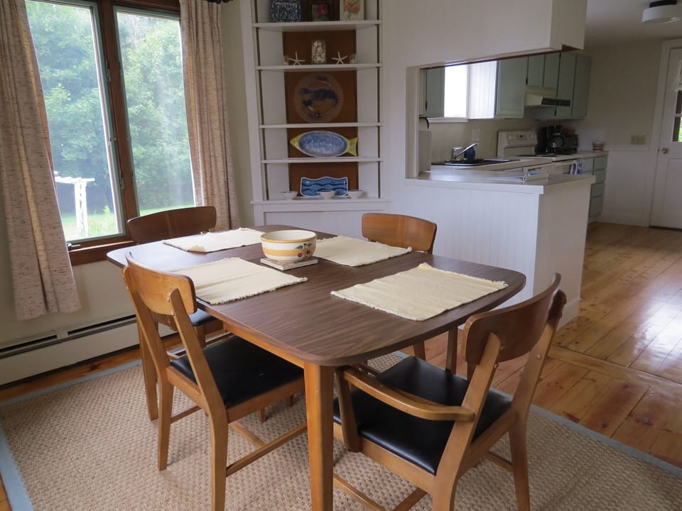 Dining room, looking into kitchen and view of backyard.