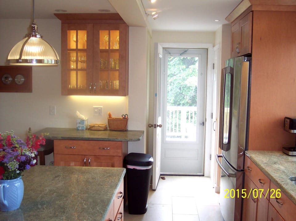 Kitchen egress to Grill Deck with picnic table, outside shower & yard below.