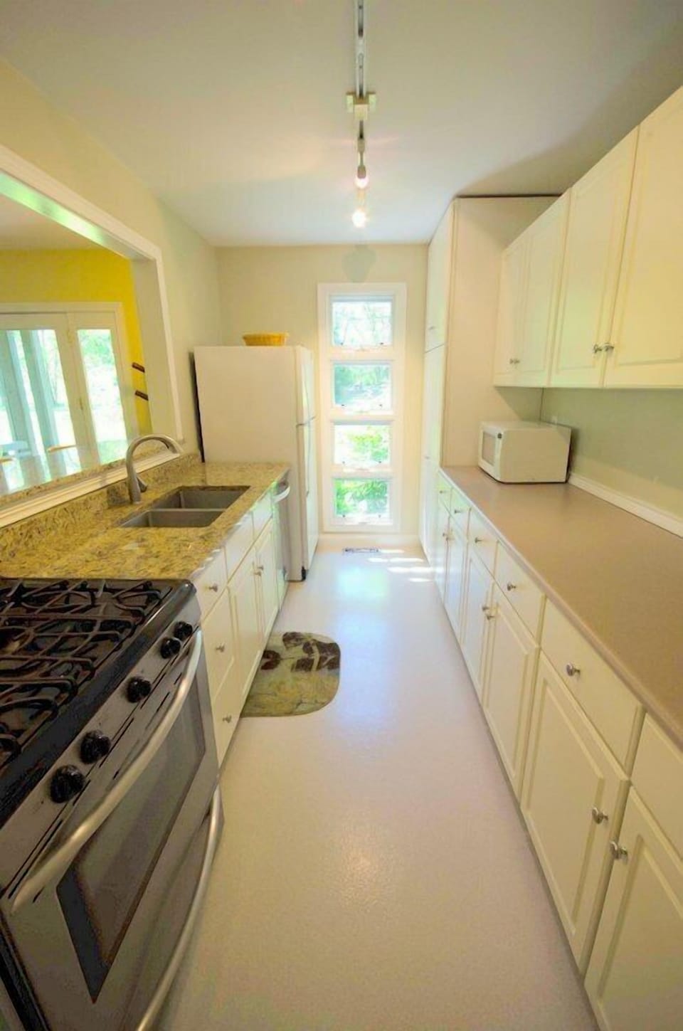 Kitchen (full size dishwasher located between sink and full size refrigerator