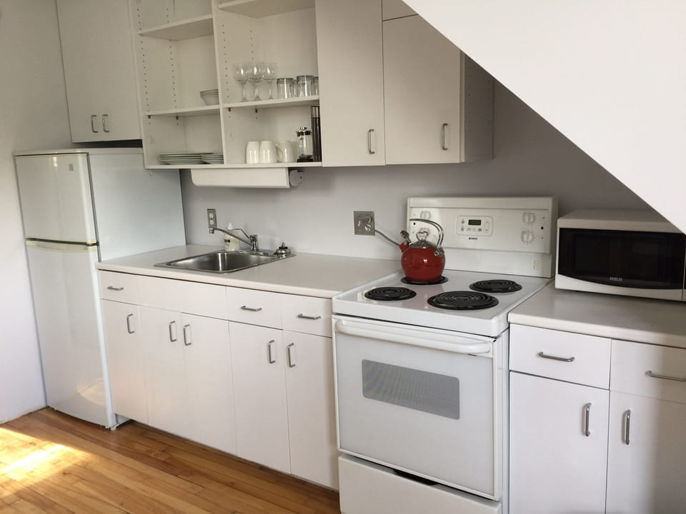 Kitchen with everything you need - kettle, coffee maker, microwave, toaster