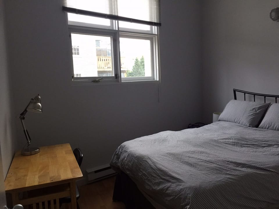Bedroom with queen sized bed and memory foam; desk, chair, side tables, lamps