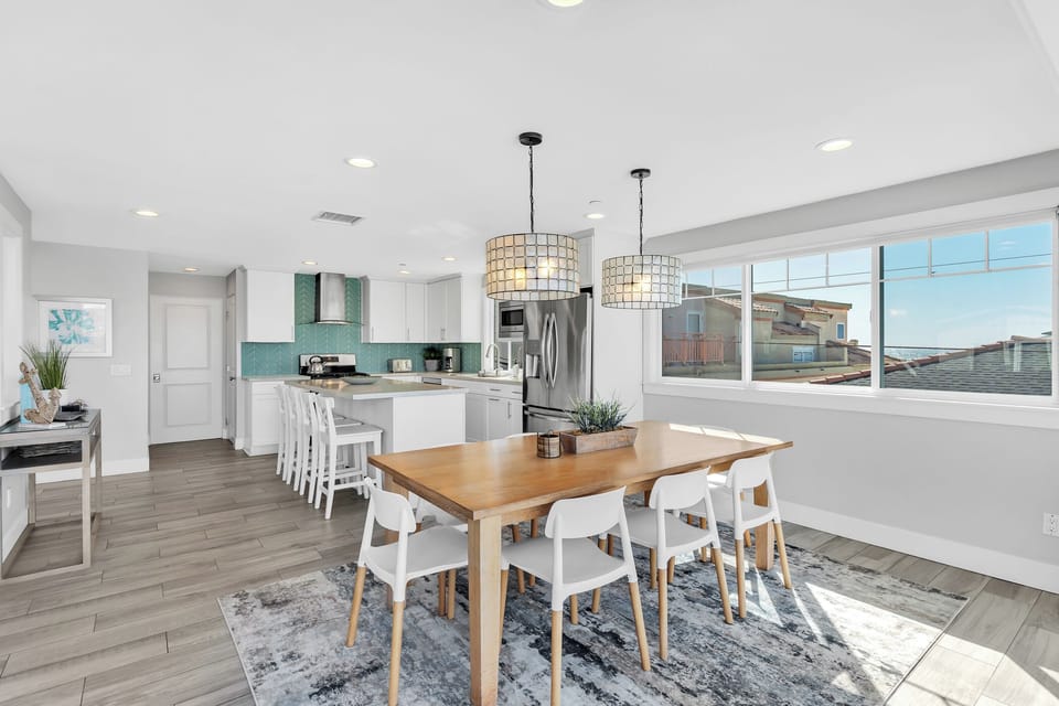 Stunning open-concept living and dining area with expansive windows, natural light, and beautiful ocean views in the heart of Mission Beach.