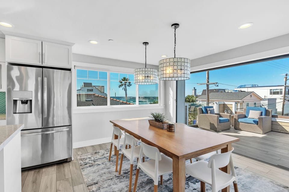 Dining table for eight with stunning natural light and ocean views-perfect for shared meals after a day at the beach.