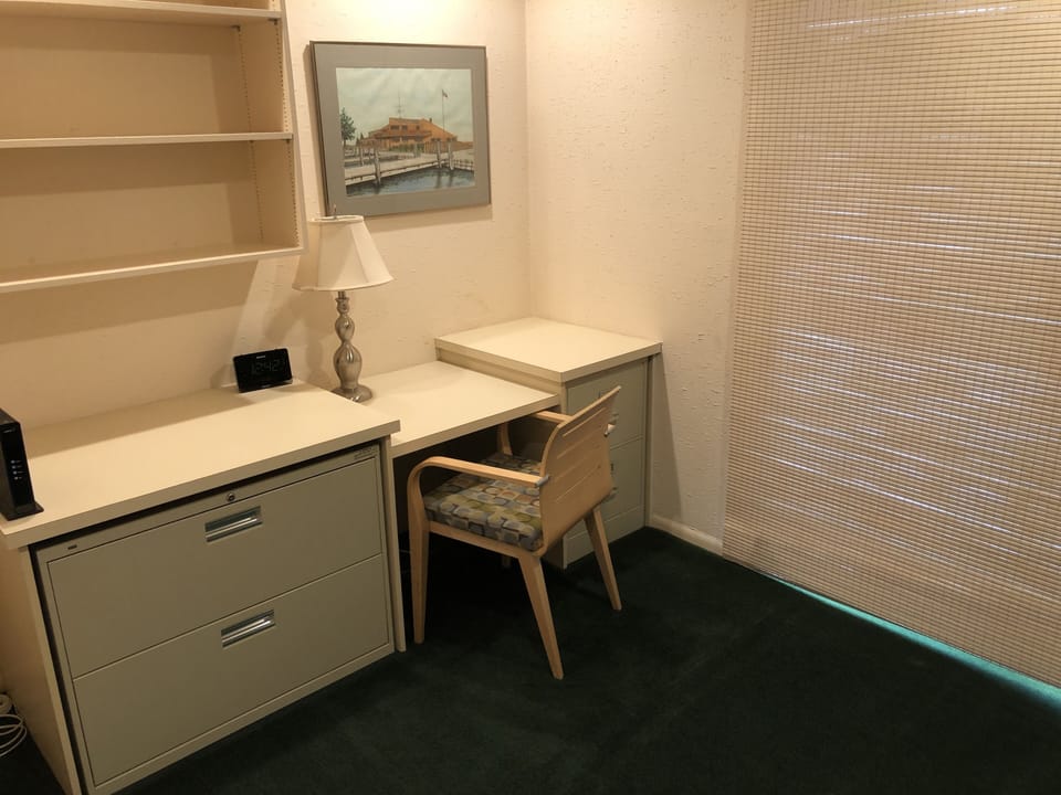 Twin bunk bedroom with desk and office chair