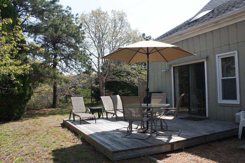 Deck with patio furniture, gas grill, and outdoor shower