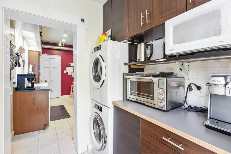 Rear entry / mudroom with guest laundry and additional appliances.