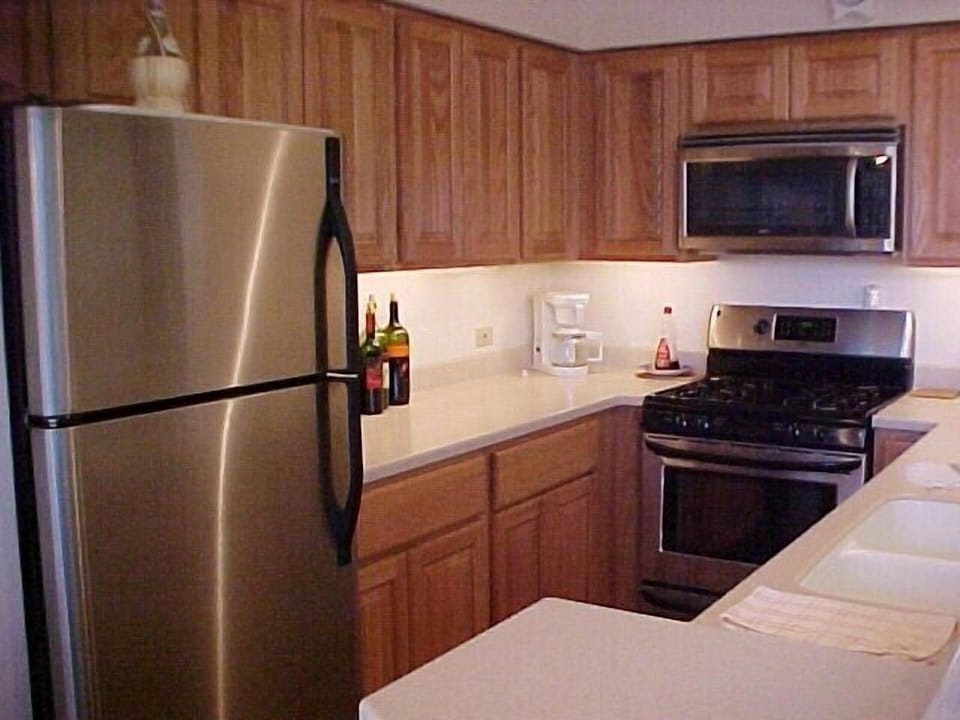 Upgraded fully stocked kitchen with stainless steel appliances.