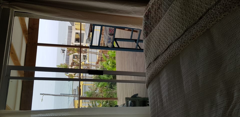Second bedroom leading out on to the sea view deck. 
