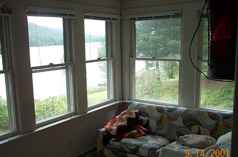 Pull out couch on front porch with lake view.  Best place for morning coffee. 