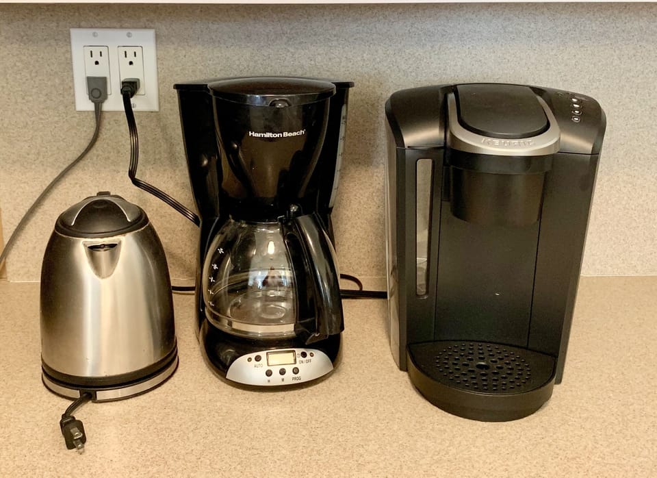 2 Coffee makers and a hot water kettle.