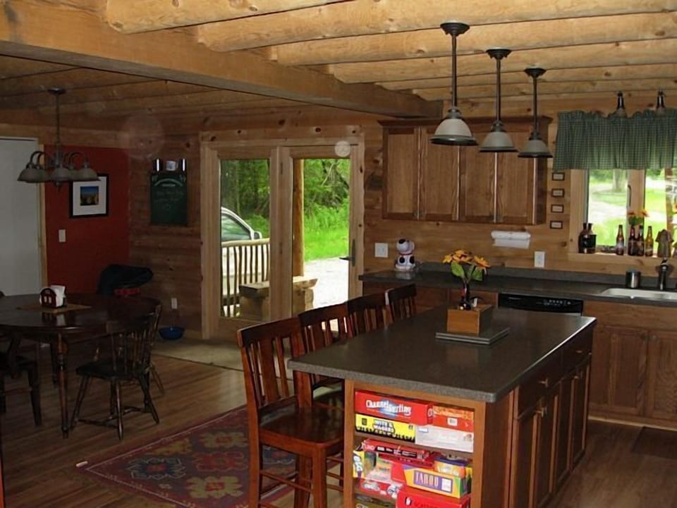 The kitchen, dining area, and front door