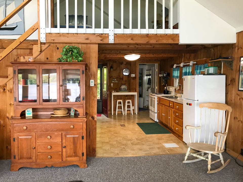 Kitchen from dining area, bath beyond on right, entry beyond on left.
