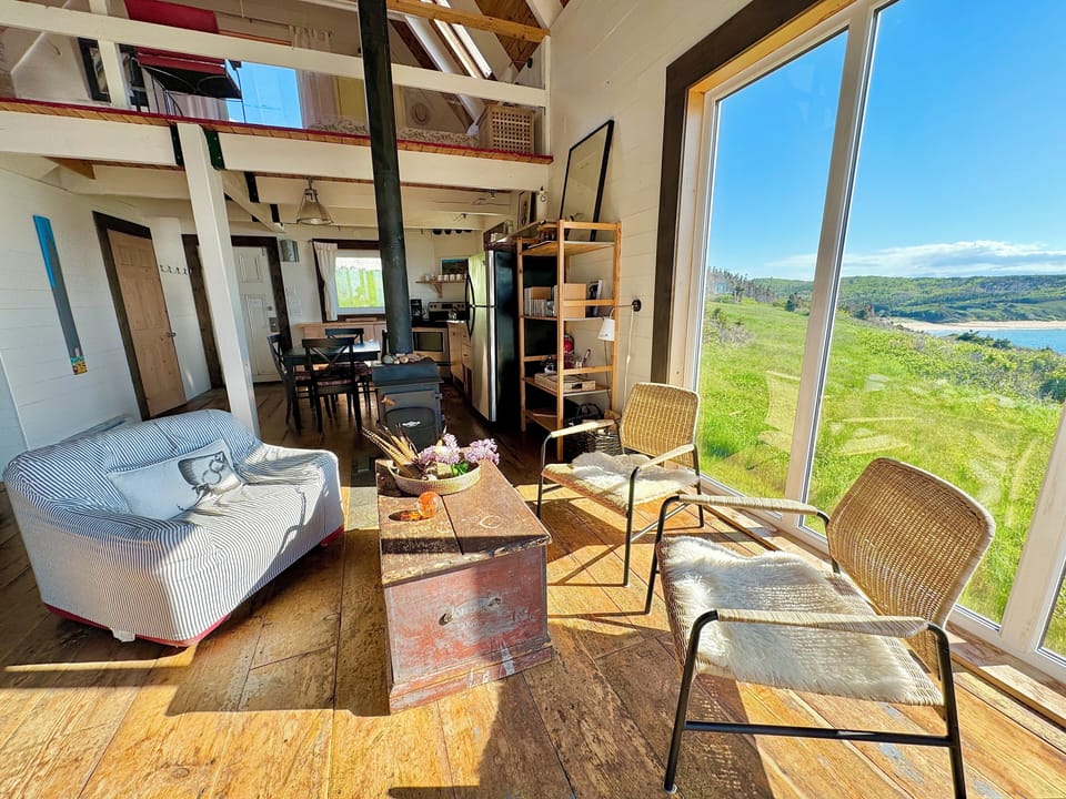 easy chairs / windows overlooking ocean– looking back toward kitchen/ 2nd floor