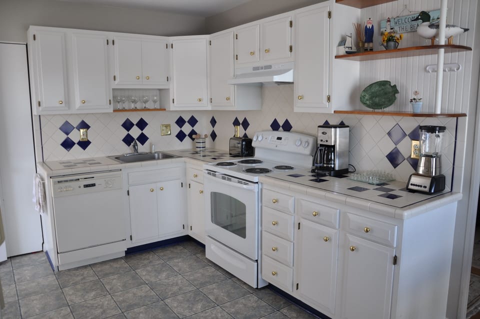Renovated Kitchen with newer fridge, GE stove and stacked Washer/Dryer
