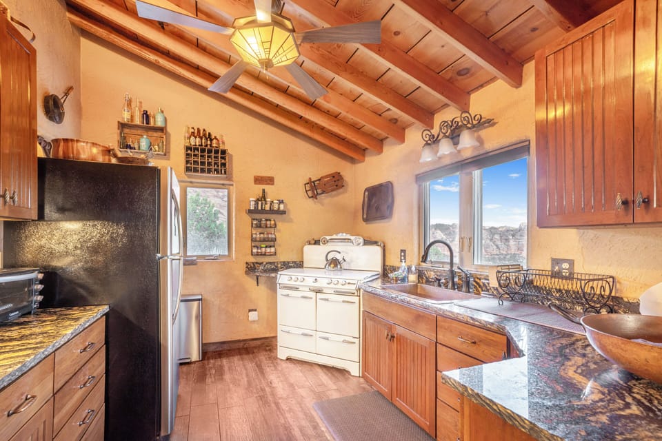 Large and fully stocked kitchen and panty offers gas stove and incredible views 