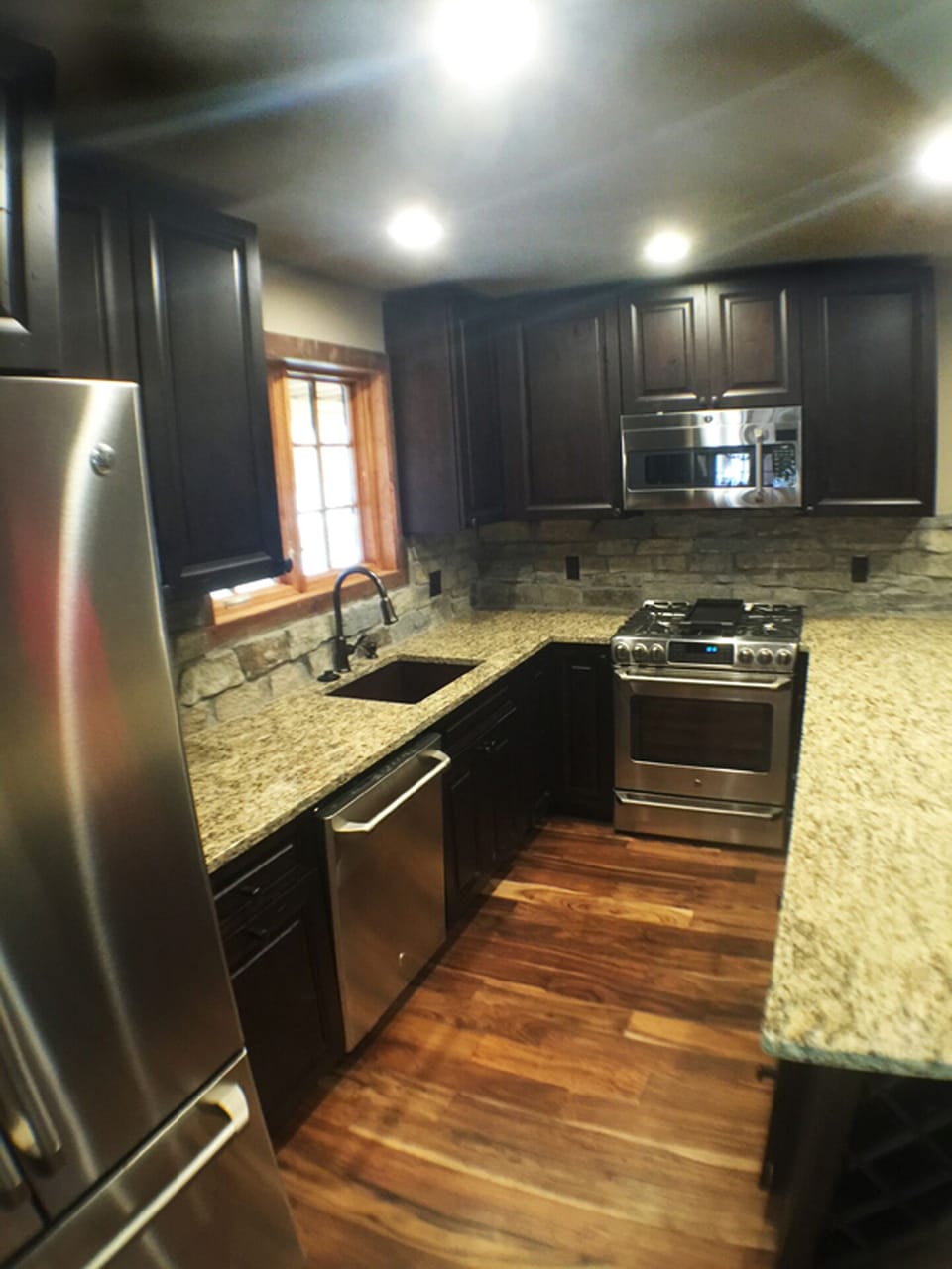 Custom high end kitchen with granite counter tops and stainless steel appliances