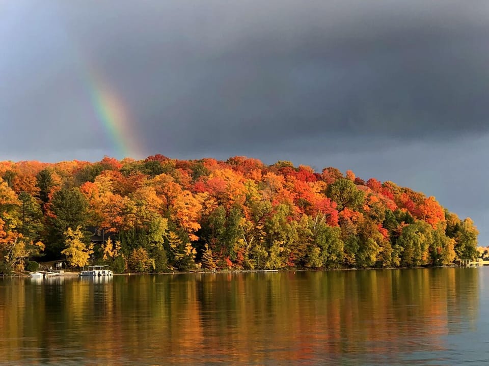 View across the lake with fall colors (and a rainbow)