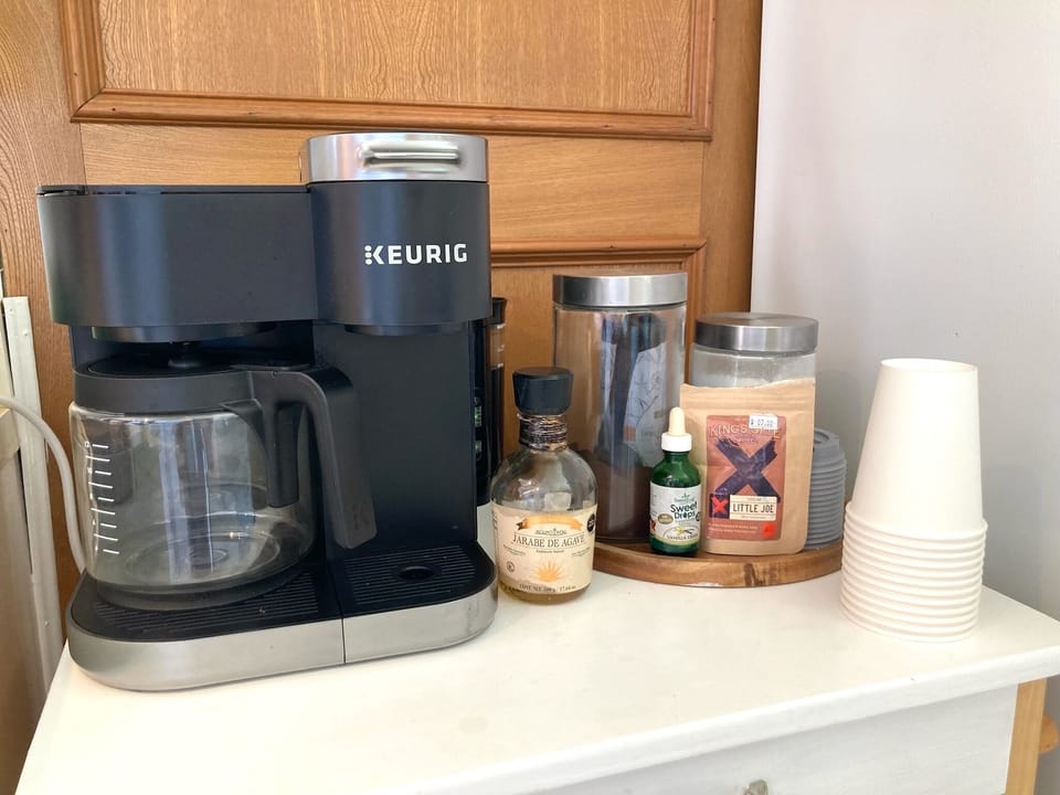 Keurig with both pods and drip coffee, cream, sugar, etc.