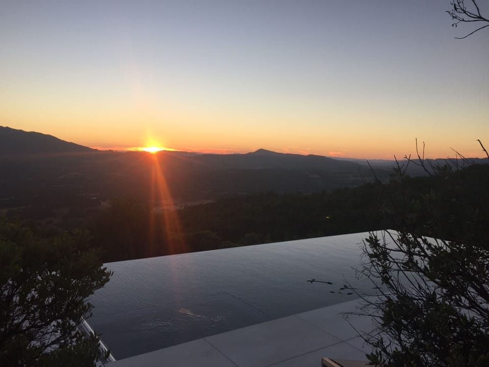 Sunset on path between the pool and the house
