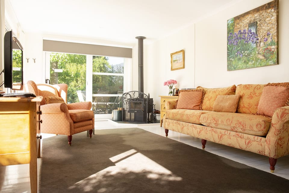 Comfortable couches and wood-heater for lazing at Dairy House.