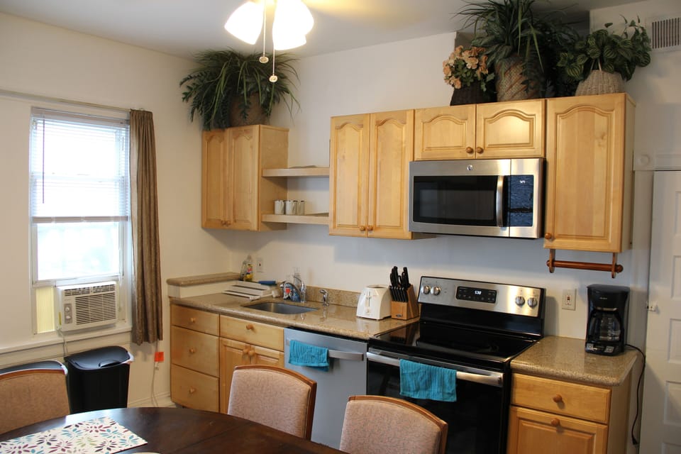 Fully stocked kitchen with full sized refrigerator.
