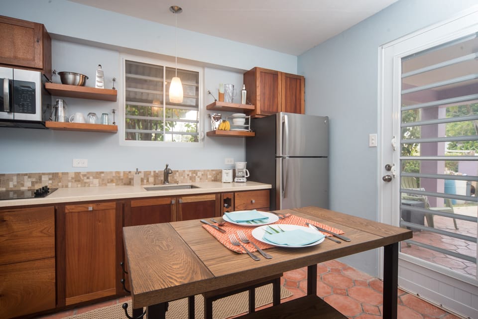 Kitchen offers a 4-burner cooktop, microwave, coffee maker, toaster & blender.