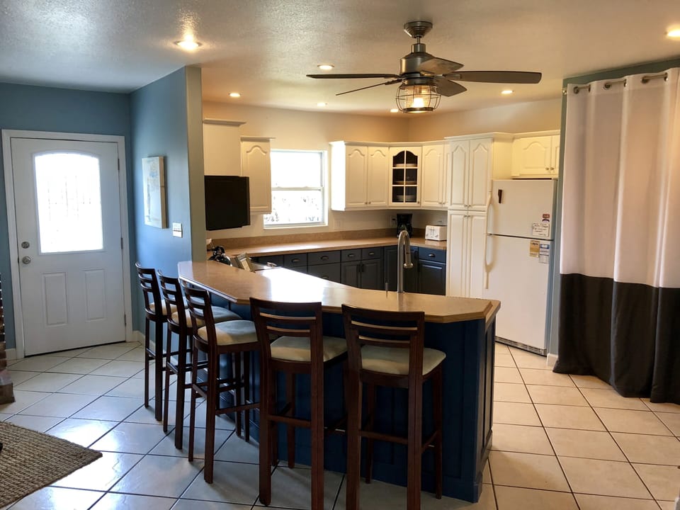 From the kitchen, one can access the back deck.