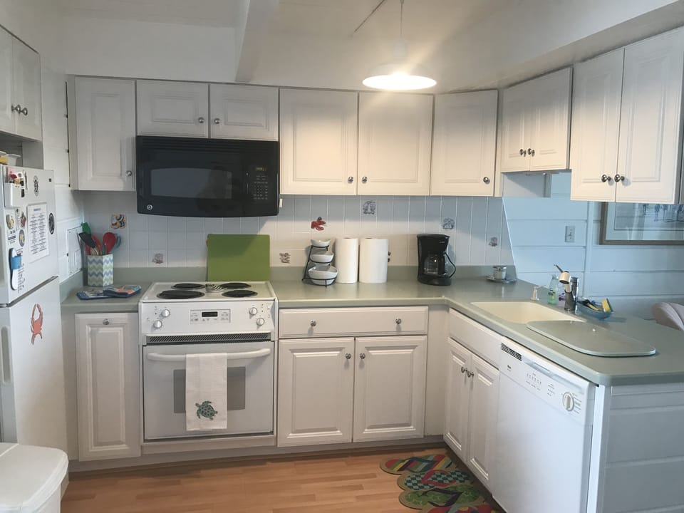 Kitchen fully stocked with blender, Keureg, coffee pot, mixer, and griddle