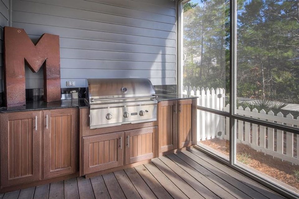 Gas grill on screened in porch.