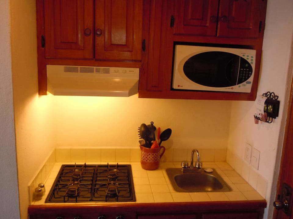 Kitchen with 4 burner gas stove, microwave; coffee maker--well-equipped.