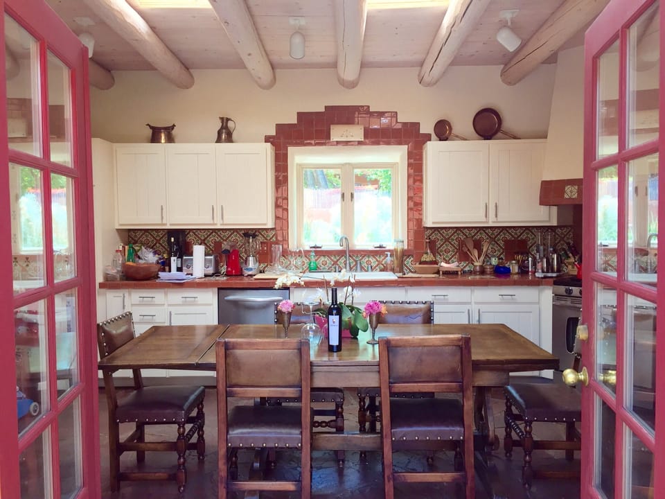 kitchen open to front courtyard - table expands to sit 10 comfortably