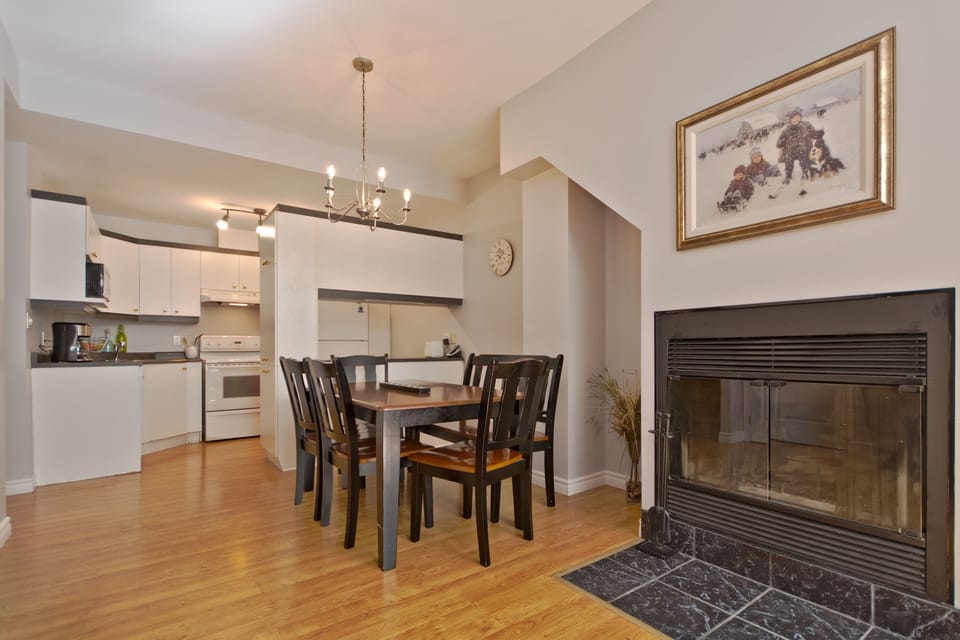 dining area next to wood fireplace - main level