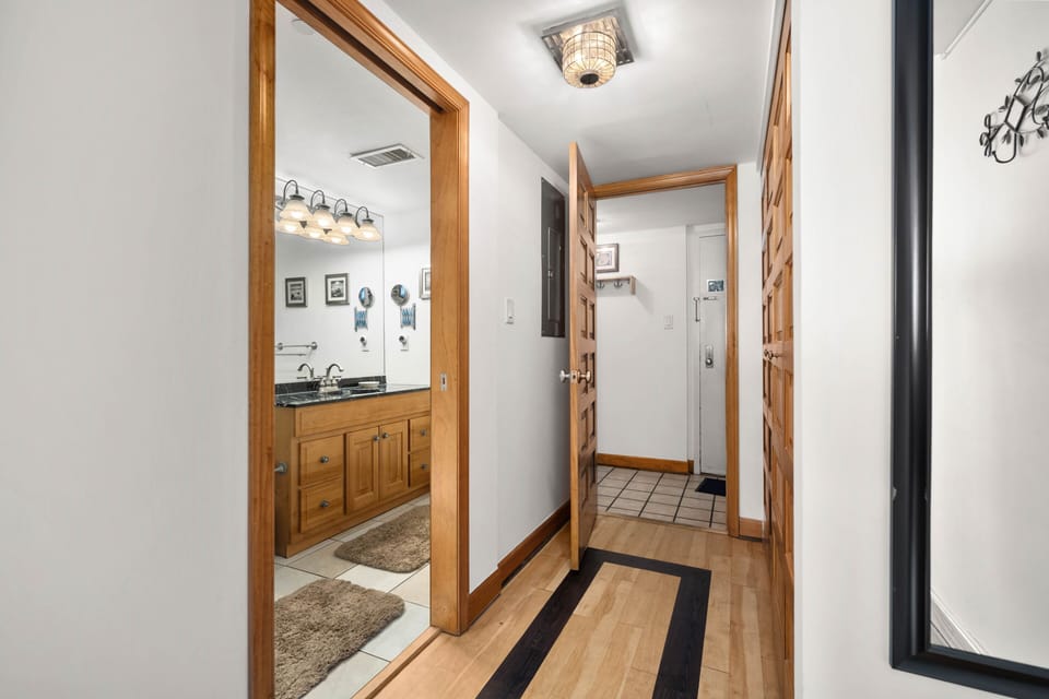 Master bedroom hallway looking into hallway.  Master bath to left.