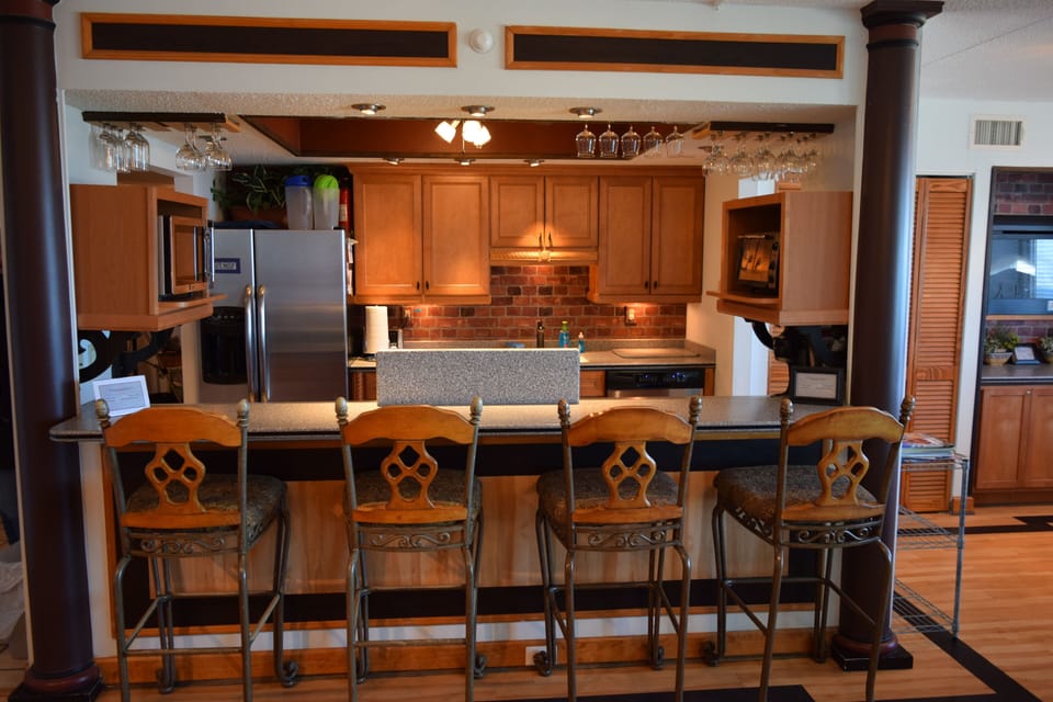 Breakfast bar & bistrow with mood lighting and hanging glassware.