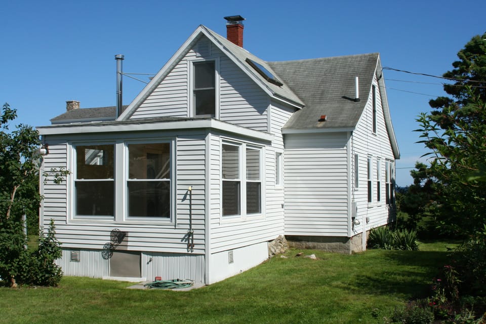 Back of cottage with outdoor shower.