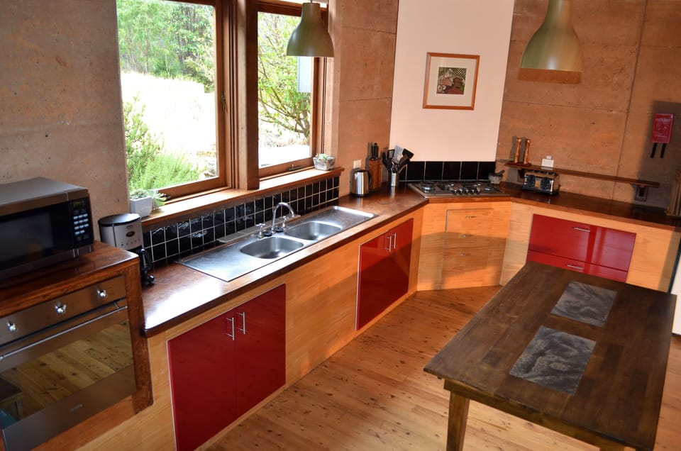 Gourmet kitchen with large windows overlooking the rosemary and lavender bushes