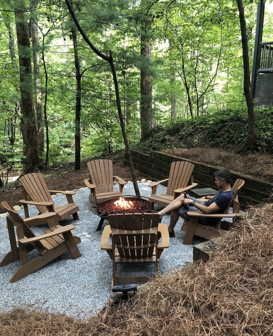 Cozy propane firepit area overlooking greenbelt near babbling stream