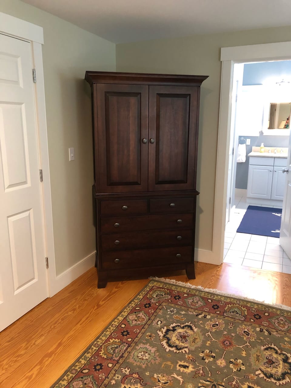 Armoire with Cable and Apple TV inside.