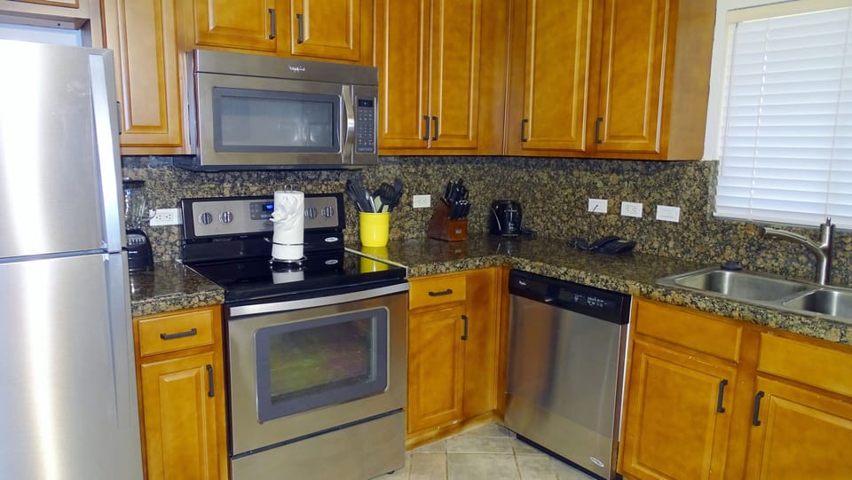 The georgeous kitchen has all of the amenities needed to make your stay enjoyable.  Included are:  coffee maker, microwave oven, dishwasher, blender, dishes (glasses, eating utensils, etc.), pots and pans, and other cooking utensils.