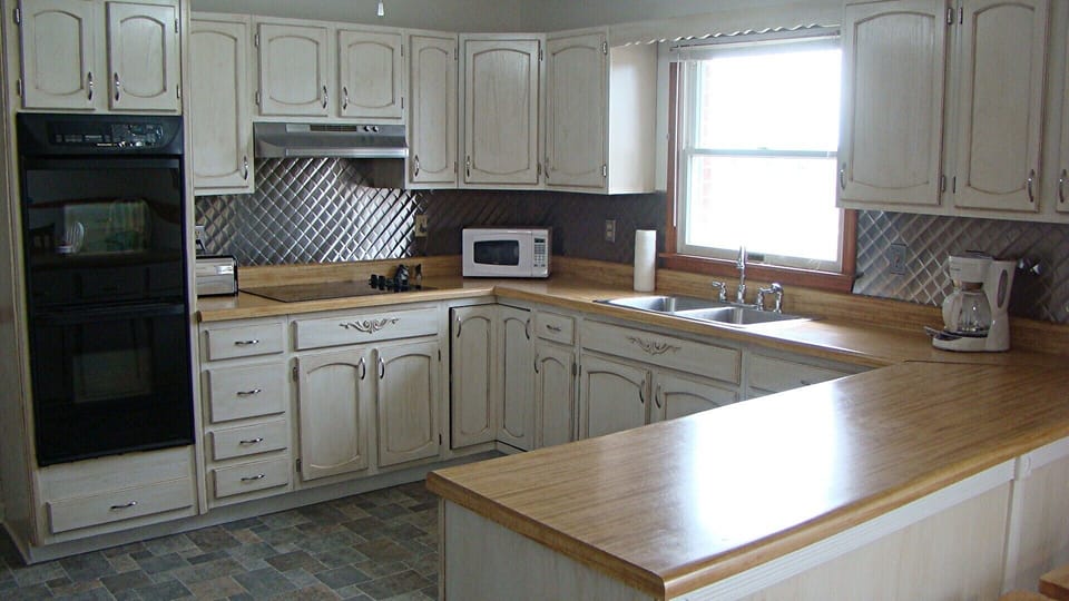 Double ovens, ceramic cooktop, dishwasher and microwave.