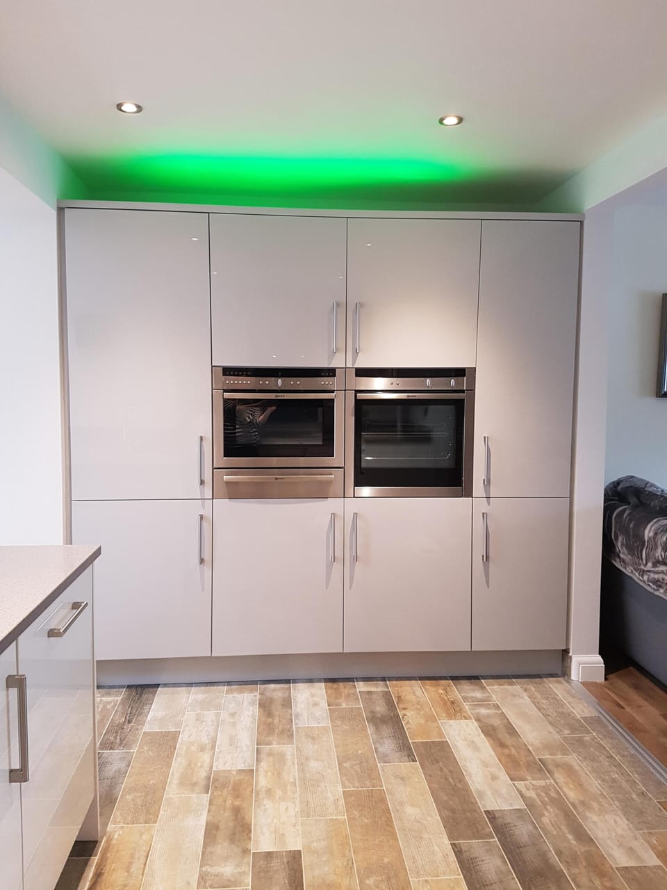 Neff cooker and microwave, built in fridge freezer. Mood lighting above.