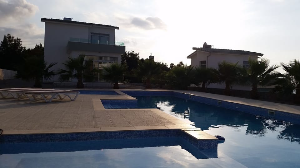 Pool area, 16m by 4m with 2 small splash pools & lovely sea views beyond