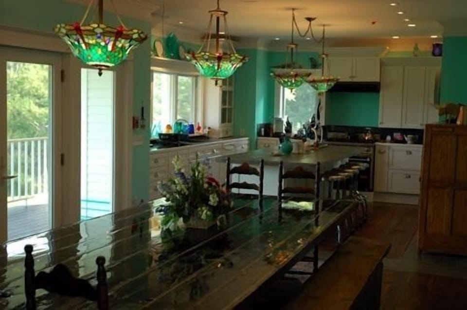 The barn door Dining Room table, seats 20, into the fully-equipped kitchen