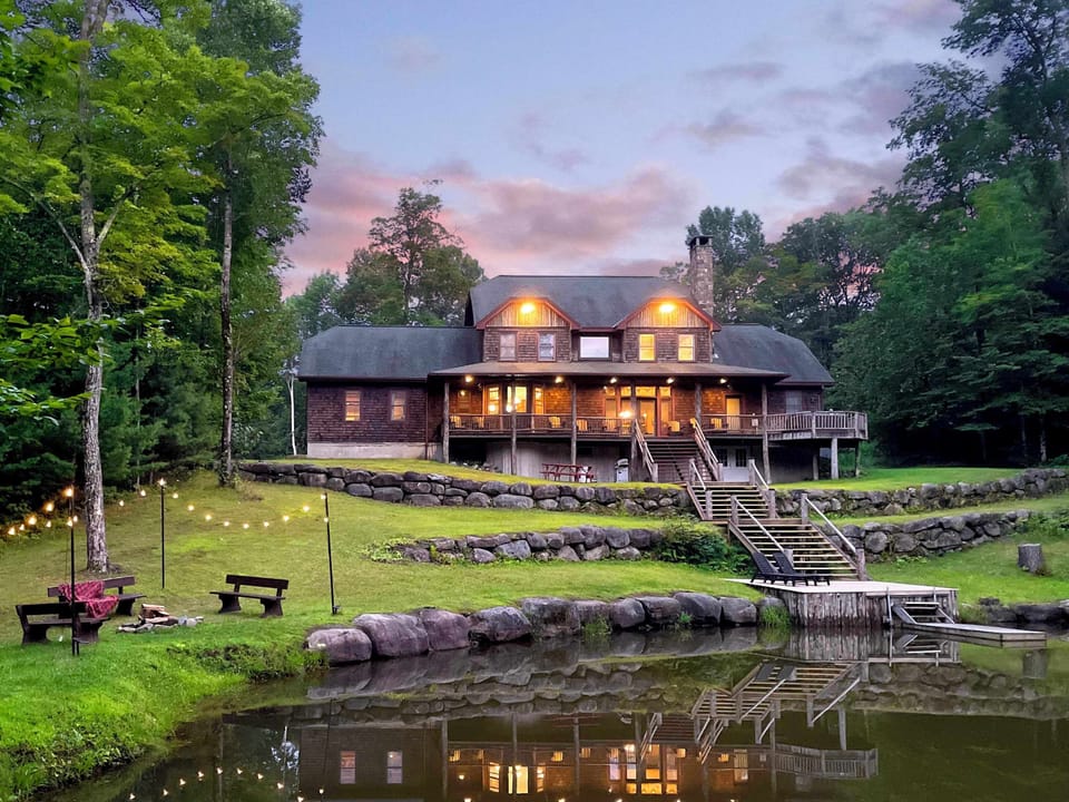 Back of House overlooking pond and fire pit