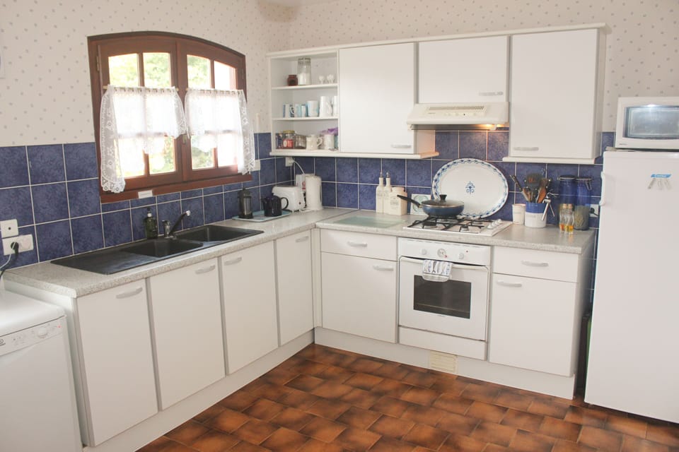Kitchen with dishwasher larder fridge, microwave etc